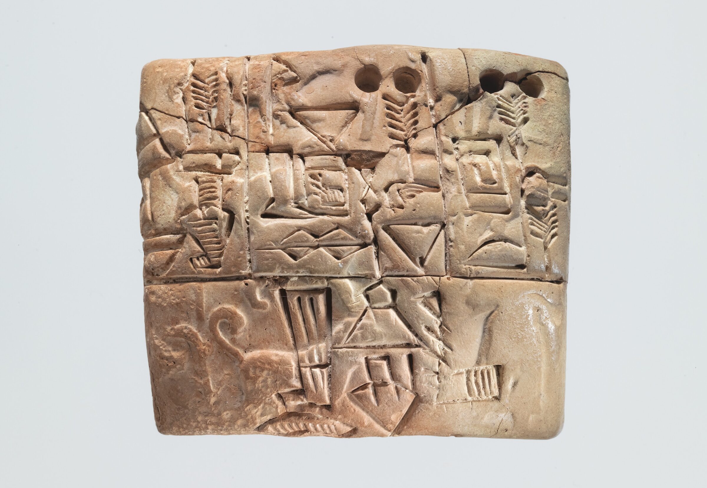 A small clay tablet with proto-cuneiform signs and seal impressions